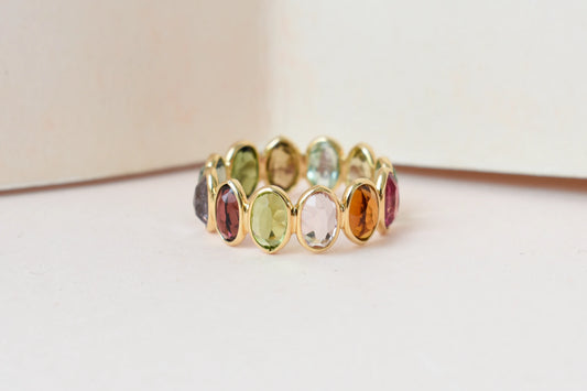Oval-cut multicolor tourmaline double-row eternity ring in 18K gold