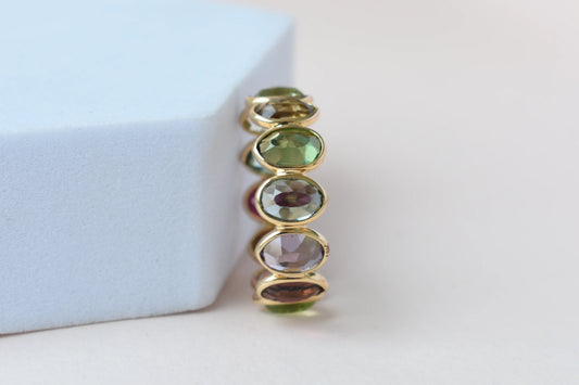Oval-cut multicolor tourmaline double-row eternity ring in 18K gold