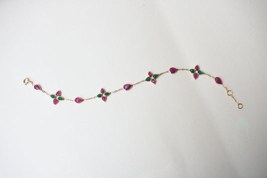 Gold bracelet with ruby and emerald quatrefoil clusters