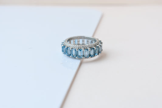 Sky blue topaz wide emerald-cut eternity ring in 925 silver