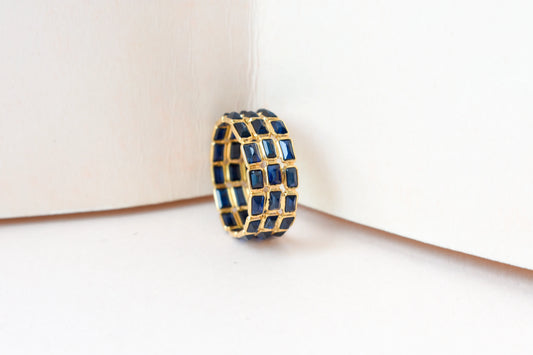 Baguette-cut blue sapphire three-row eternity ring in 18K gold