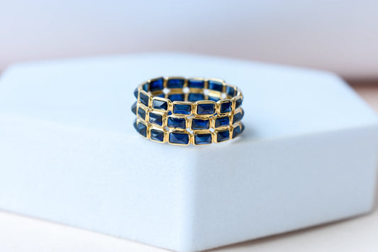 Baguette-cut blue sapphire three-row eternity ring in 18K gold