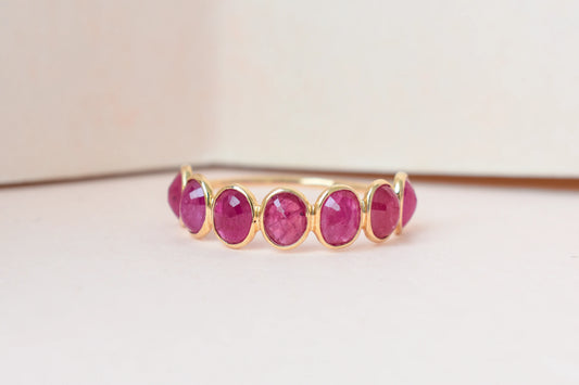 Oval-cut ruby single-row eternity ring in 14K gold