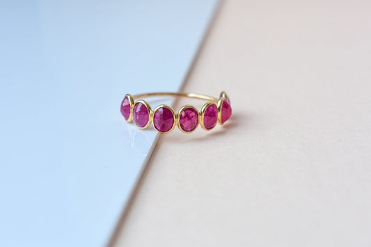 Oval-cut ruby single-row eternity ring in 14K gold