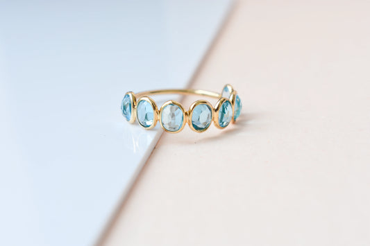 Oval-cut Swiss blue topaz single-row eternity ring in 14K gold