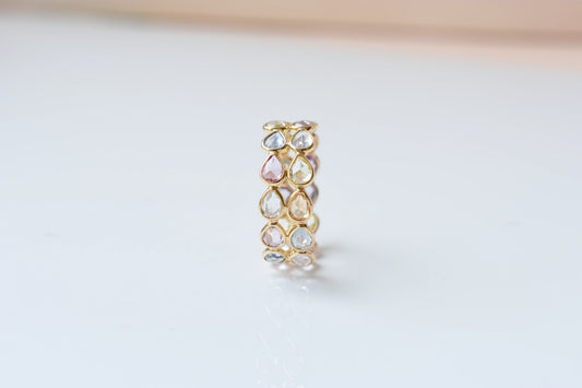 Pear-cut pastel multicolor sapphire eternity ring in 18K gold