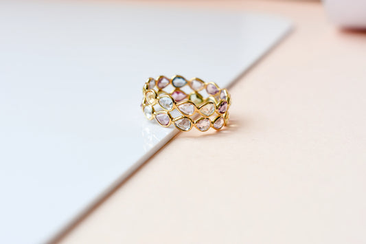 Pear-cut pastel multicolor sapphire eternity ring in 18K gold