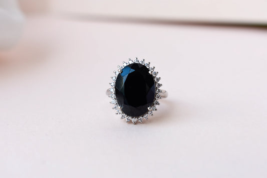 Oval black onyx halo ring in 925 silver with white cubic zirconia border
