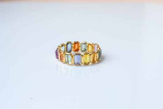 Emerald-cut multicolor sapphire eternity ring in 18K gold