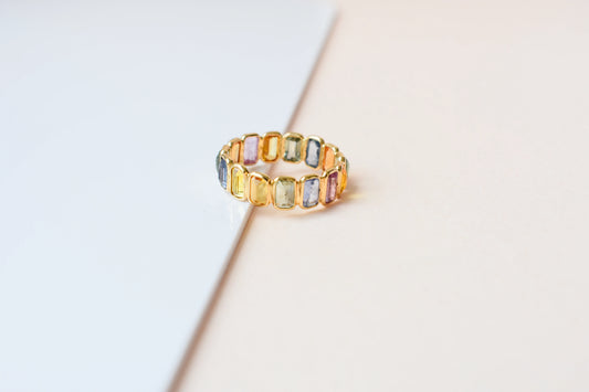 Emerald-cut multicolor sapphire eternity ring in 18K gold