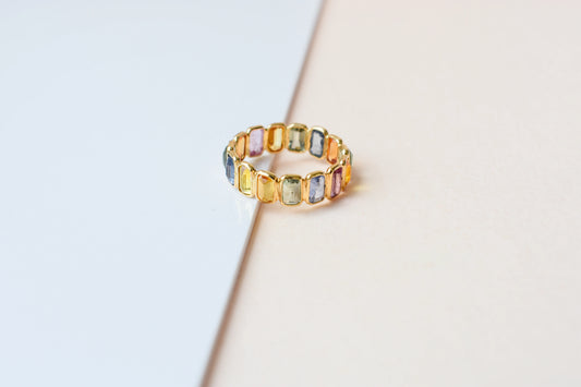 Emerald-cut multicolor sapphire eternity ring in 18K gold