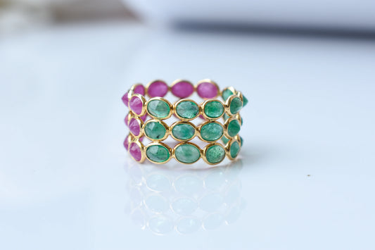 Two-tone emerald and ruby eternity ring in 18K gold