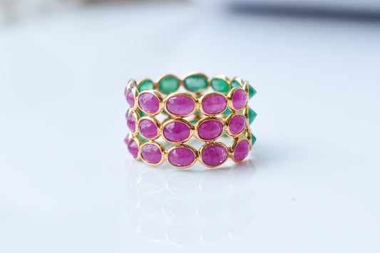 Two-tone emerald and ruby eternity ring in 18K gold