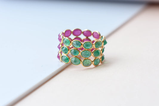 Two-tone emerald and ruby eternity ring in 18K gold