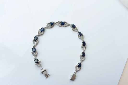 Blue gemstone oval tennis bracelet in 925 silver with pavé accents