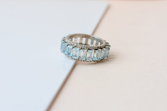 Sky blue topaz emerald-cut eternity ring in 925 silver