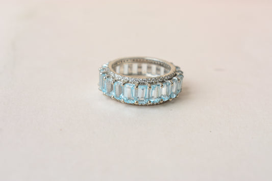 Sky blue topaz emerald-cut eternity ring in 925 silver