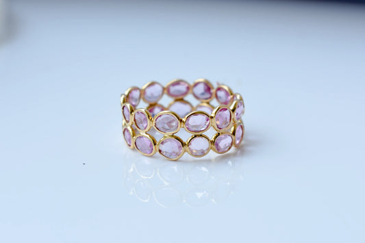 Oval-cut pink sapphire double-row eternity ring in 18K gold