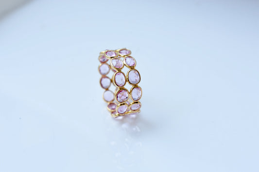 Oval-cut pink sapphire double-row eternity ring in 18K gold