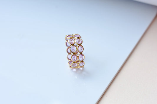 Oval-cut pink sapphire double-row eternity ring in 18K gold