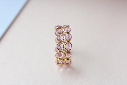 Oval-cut pink sapphire double-row eternity ring in 18K gold