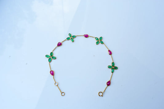 18K gold bracelet with emerald quatrefoil clusters and ruby drops