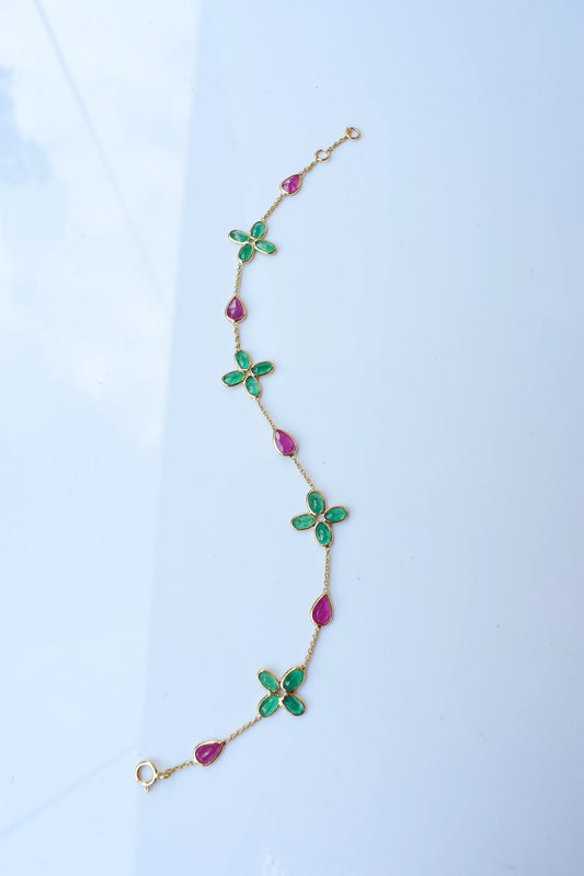 18K gold bracelet with emerald quatrefoil clusters and ruby drops