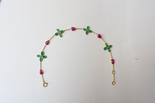 18K gold bracelet with emerald quatrefoil clusters and ruby drops