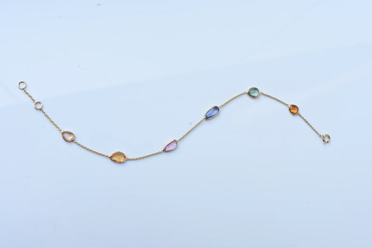 18K gold bracelet with organic-cut multi-coloured sapphire stations