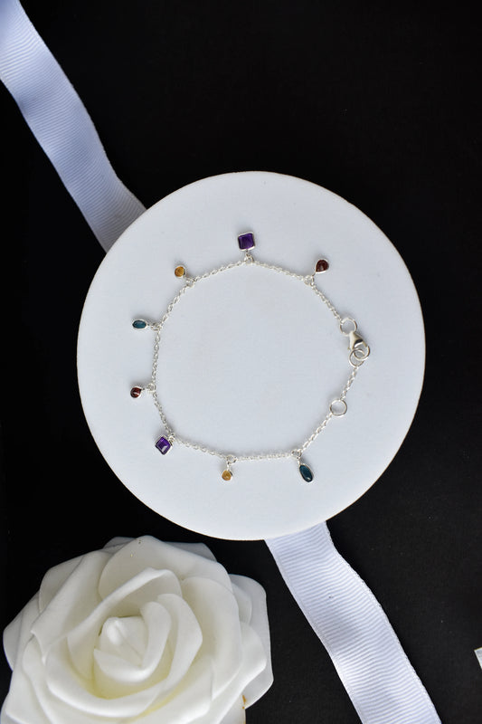 Multi gemstone charm bracelet with mixed-cut colored stones on a 925 silver chain
