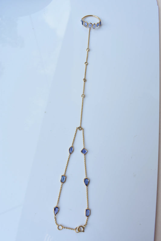 18K gold hand chain with tanzanite ring and diamond wrist accents