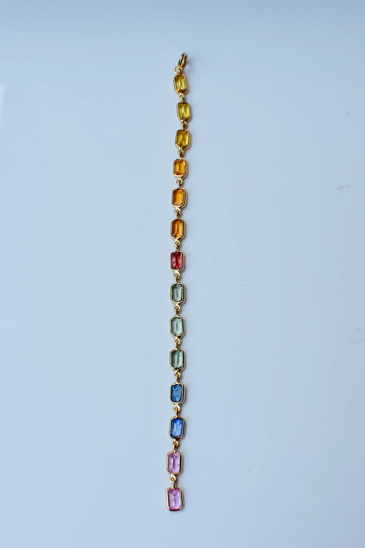 18K gold pendant with a graduated line of bezel-set multicolor sapphires