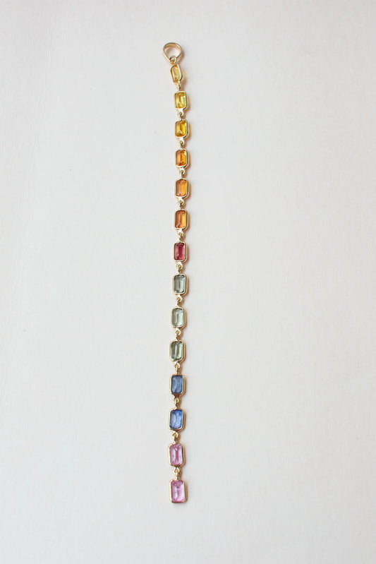 18K gold pendant with a graduated line of bezel-set multicolor sapphires