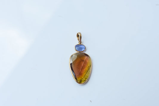 18K gold pendant with tourmaline slice and tanzanite accent