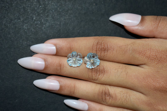 Carved blue topaz flower stud earrings with diamond centre