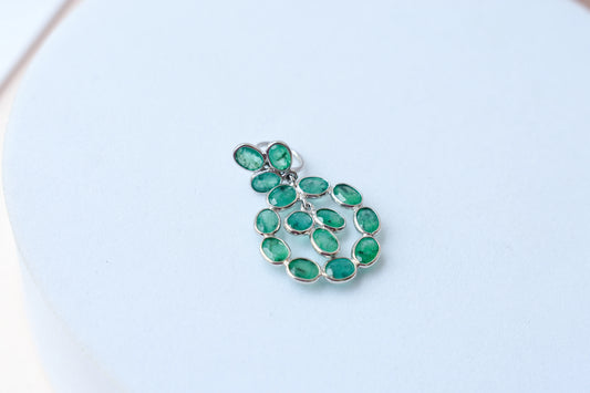 14K gold pendant with a wreath of bezel-set emeralds