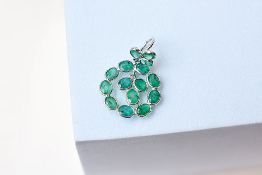 14K gold pendant with a wreath of bezel-set emeralds