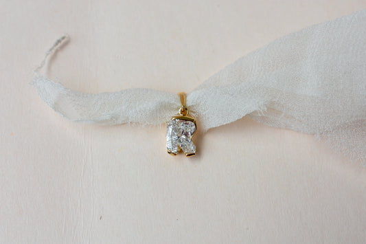 18K gold pendant with lab-grown diamond cut into the letter R