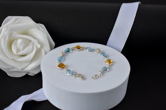 Citrine and blue topaz dangle bracelet with cubic zirconia accents in 925 silver