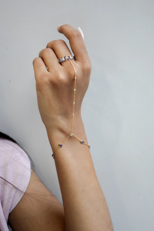 18K gold hand chain with tanzanite ring and diamond wrist accents