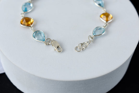 Citrine and blue topaz dangle bracelet with cubic zirconia accents in 925 silver