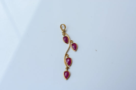 18K gold pendant with four bezel-set pear rubies on a vine design