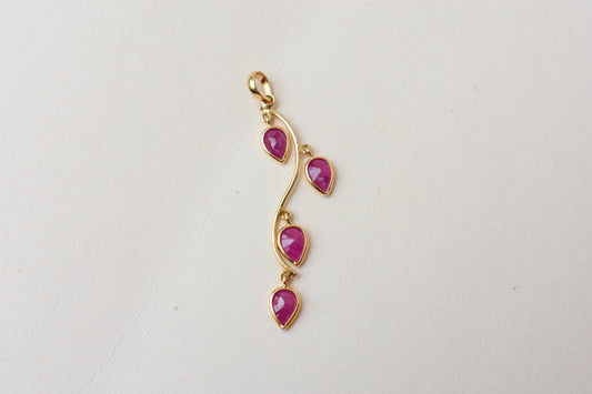 18K gold pendant with four bezel-set pear rubies on a vine design