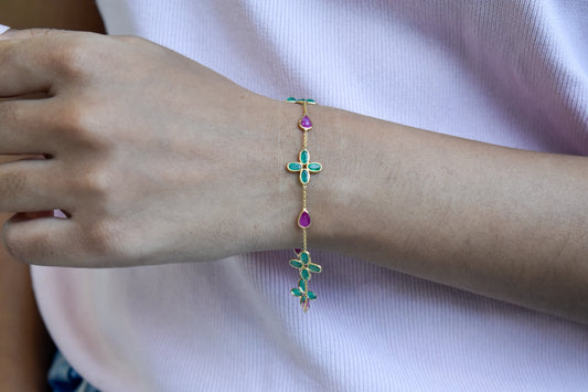 18K gold bracelet with emerald quatrefoil clusters and ruby drops