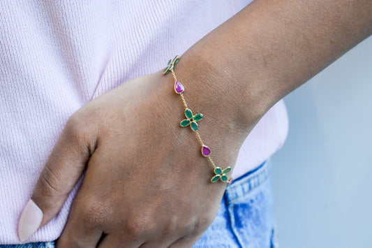 18K gold bracelet with emerald quatrefoil clusters and ruby drops