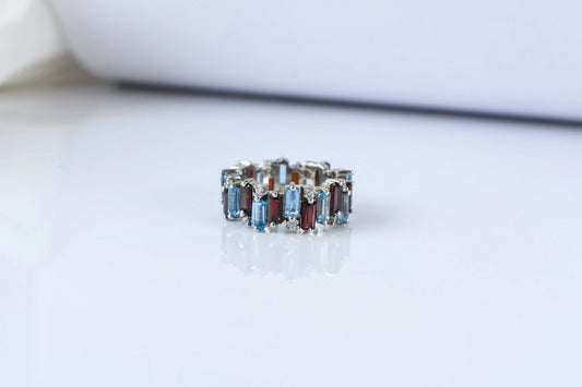 Multi gemstone baguette eternity ring with garnet and Swiss blue topaz in 925 silver