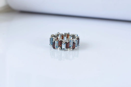 Multi gemstone baguette eternity ring with garnet and Swiss blue topaz in 925 silver