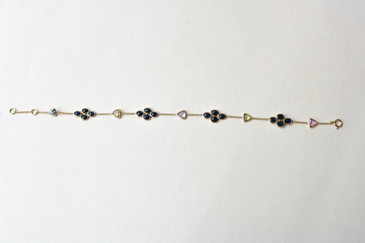 18K gold bracelet with blue sapphire clusters and multi-color trillion sapphire accents