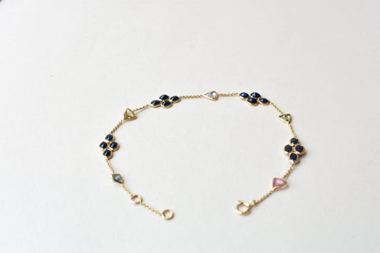 18K gold bracelet with blue sapphire clusters and multi-color trillion sapphire accents