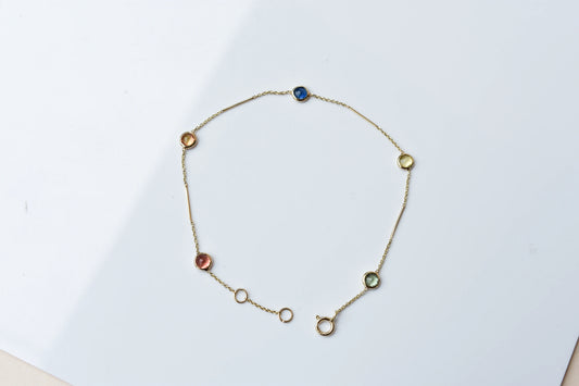 14K gold bracelet with rainbow sapphire bezels and bar links